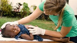Nurse treating baby